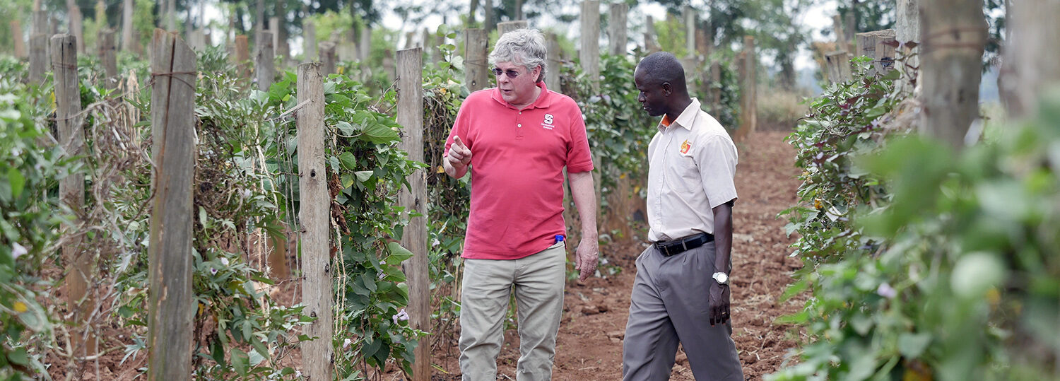 Craig Yencho and Bernard Yada research farm in Uganda